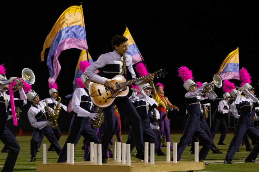 Tony Valera, a junior, plays the electric guitar for the Spartans Regiment Pink Out game performance in October. In addition to playing in the marching band, Valera is a member of the Jazz Ensemble and the Wind Ensemble.