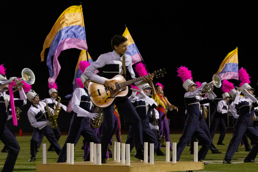 Tony Valera, a junior, plays the electric guitar for the Spartan's Regiment Pink Out game performance in October. In addition to playing in the marching band, Valera is a member of the Jazz Ensemble and the Wind Ensemble.