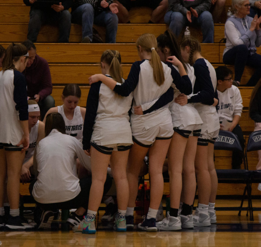 The girls huddle around their coach so they know what to do in the game 