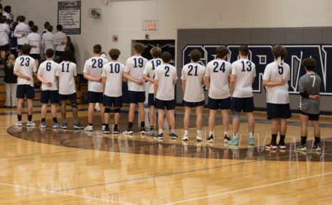 The boys volleyball waiting for the national anthem to play.