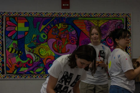 Seniors Elaina Rainwater, Maddie Arle, and Magi Temelkova work the mural.