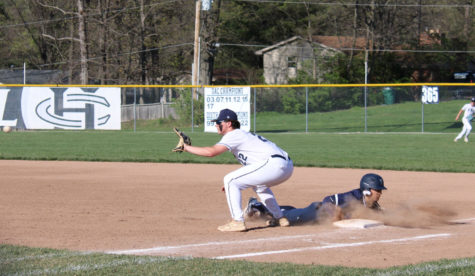 Lucas Pearson tries to get the Timberland player out on first base.