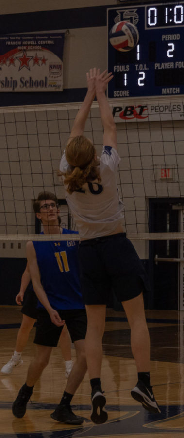 Sophomore Andrew Meurer jumping to block the ball.