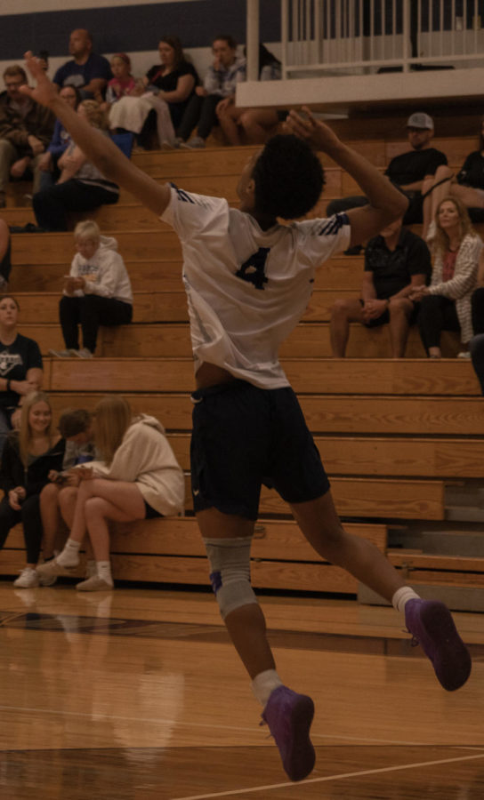 Sophomore Antonio Payton jumping to serve the ball.