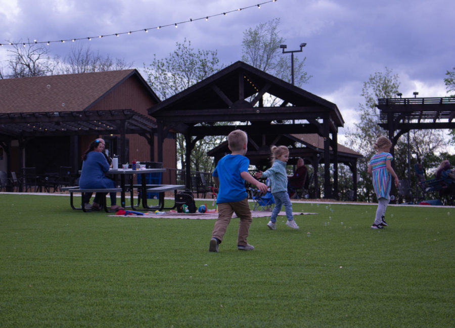 A group of children play together on the grounds of Frankie Martins.