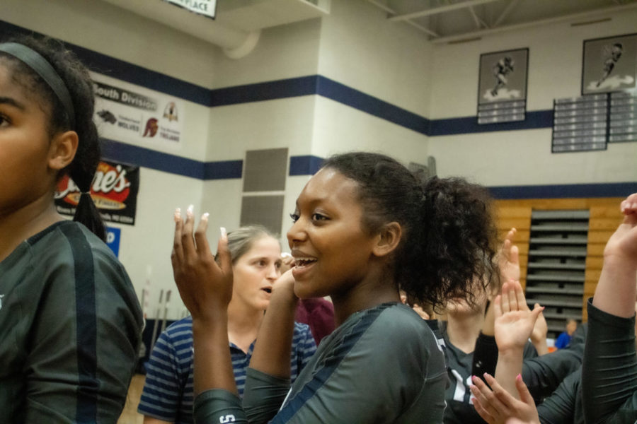 Zariya Robertson motivates her team during timeout at a girls varsity volleyball game.