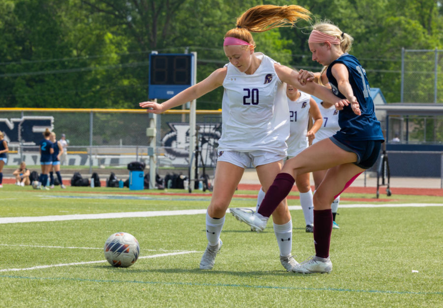 Claire Sanders kicks the ball away from Troy.