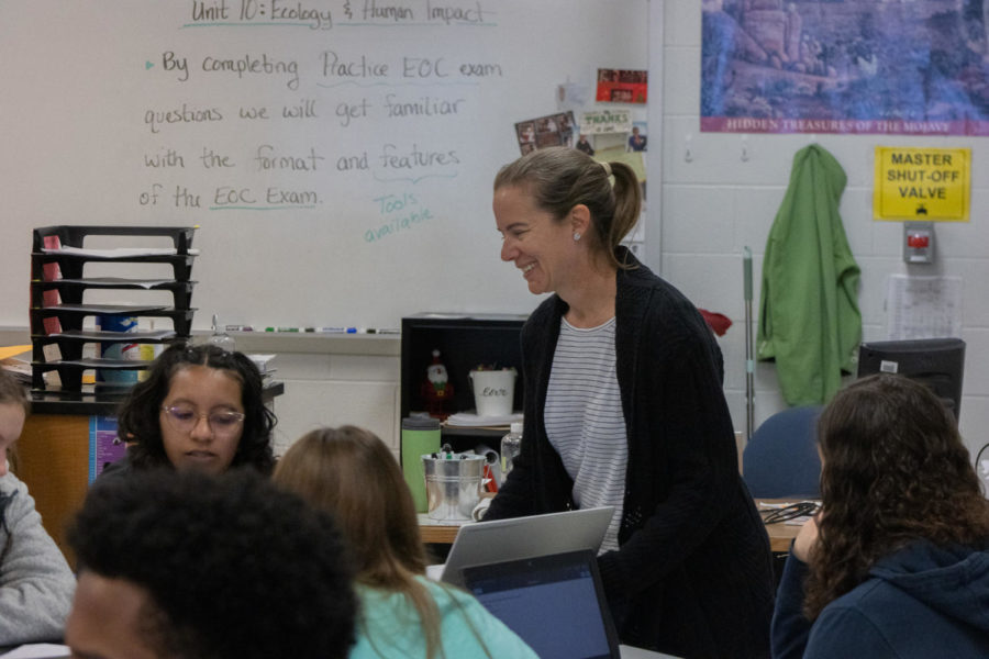 Mrs. Rowe smiles as she helps a student. Mrs. Rowe is also the sponsor of HOSA. 