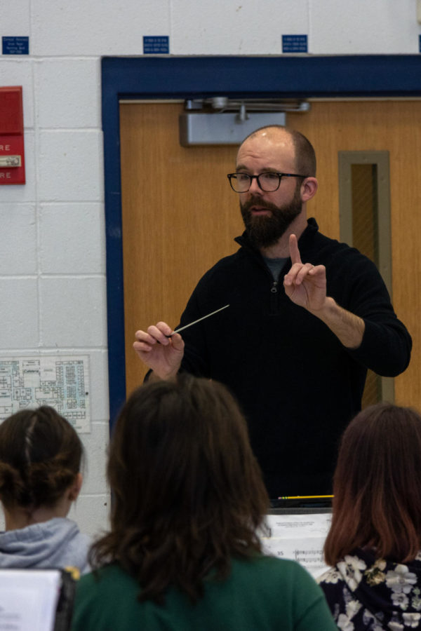 Raising his baton, music teacher Andy Messerli prepares to conduct his third hour band class. 