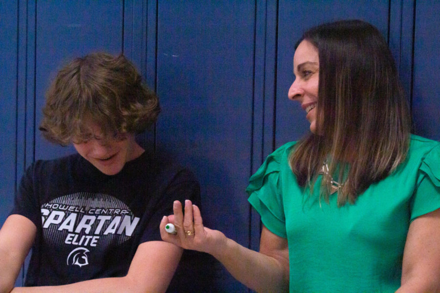 Math teacher Dena Dauve consults with a student in the hallway outside the classroom. 