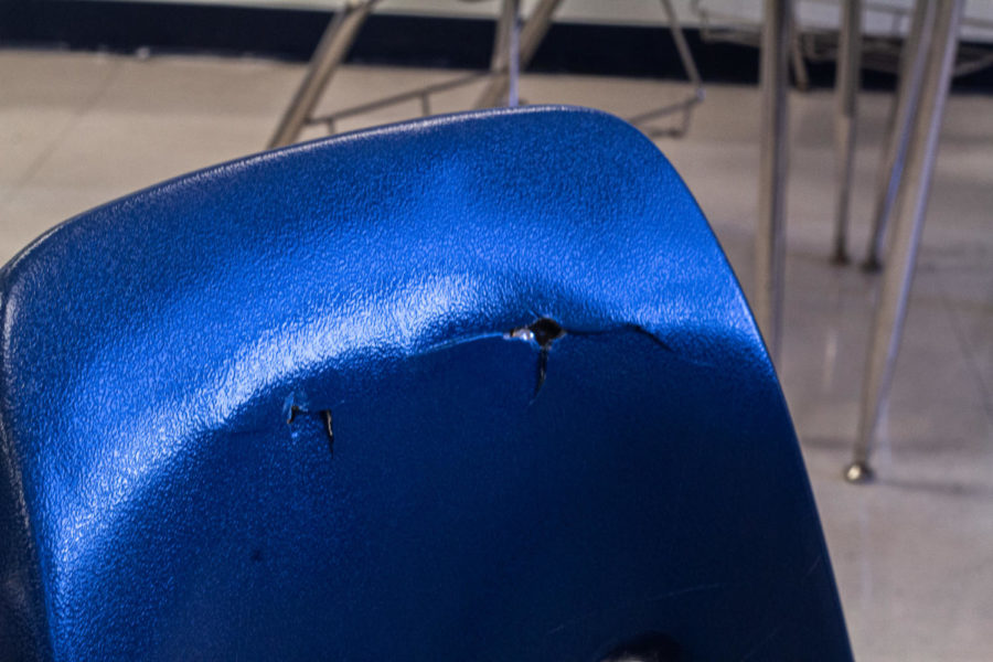 One of many cracked chairs in the school remain available for student use.  Complaints regarding the damaged chairs have begun to make their way into the daily conversations among students. (Bella Smith)