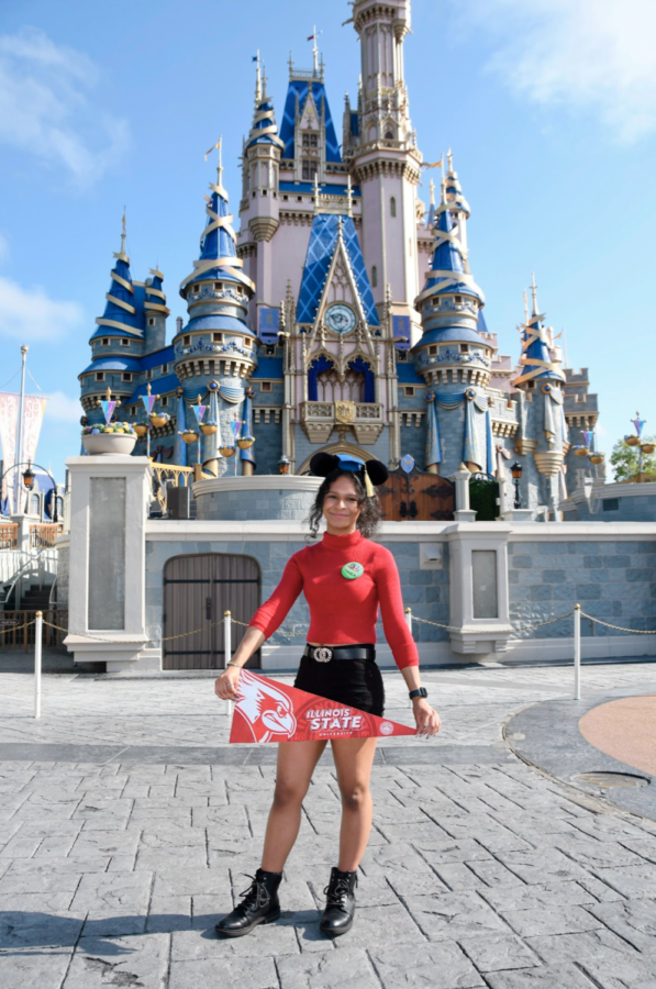 Amber Davis poses for a picture at Disney Worlds Magic Kingdom park during a vacation taken partly in celebration of her high school achievements. She is holding a banner for her school of choice, Illinois State University, where she will major in Interdisciplinary Creative Technologies. (Disney Photopass)