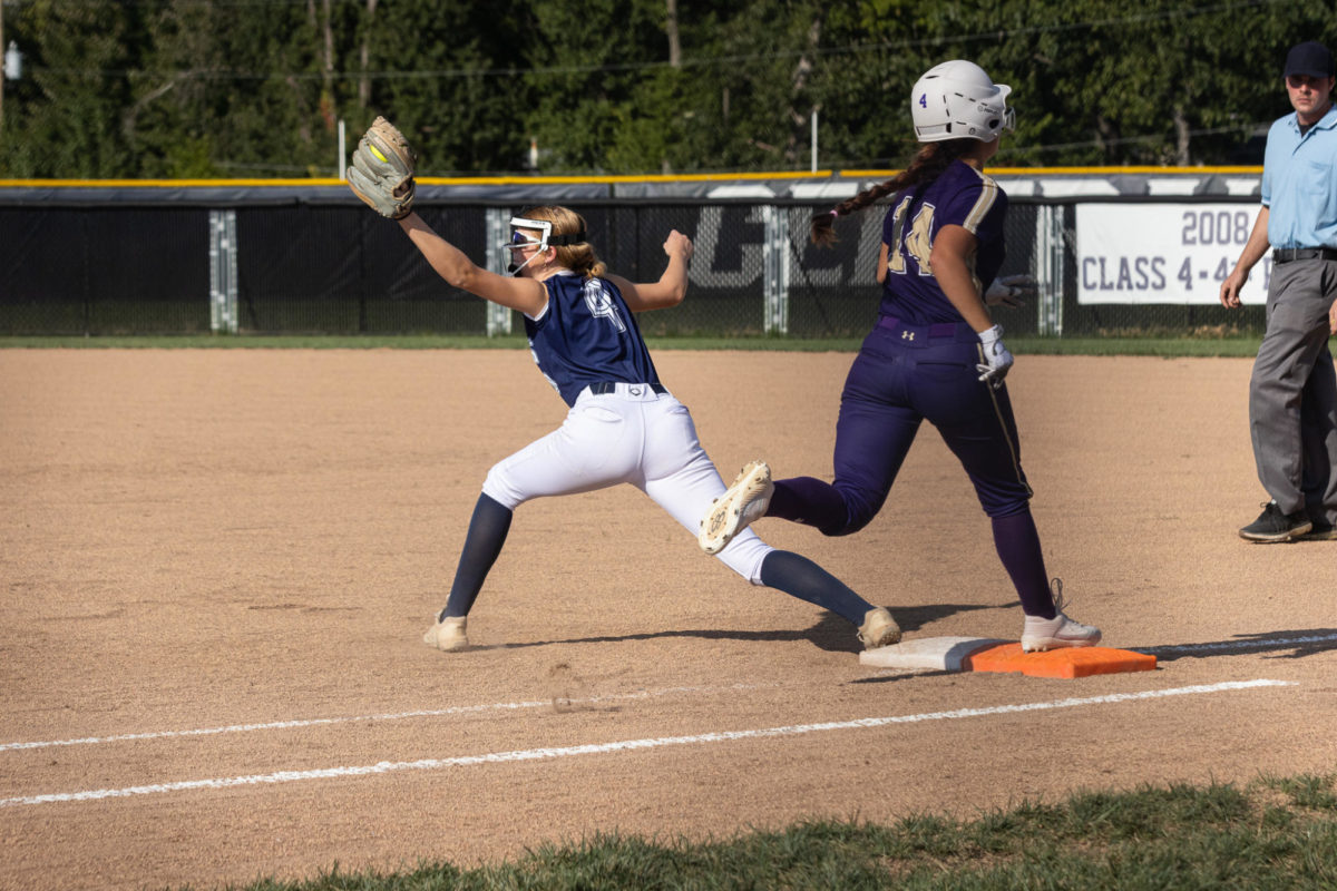 Junior Maggie Meyer makes a reach to catch the ball in order to tag out Troy Buchanans first batter.