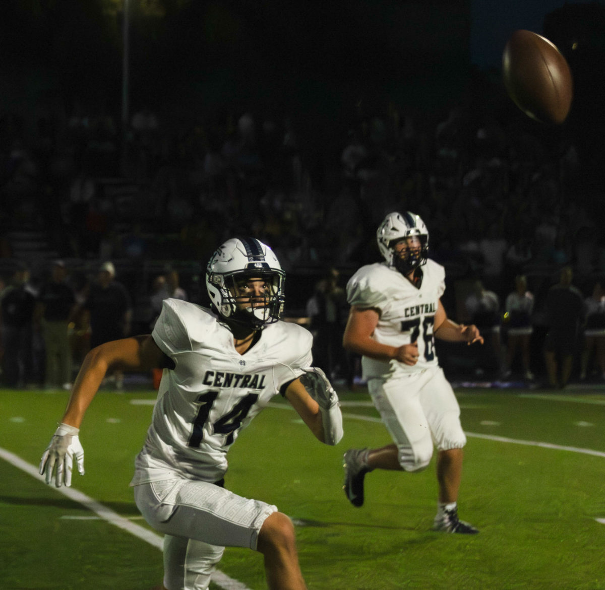 Junior Grayson Graham sprints toward the ball in hopes of making an interception against the Troy Buchanan Trojans. Junior Seamus Lawless watches eagerly in the background on Sept. 15. 
