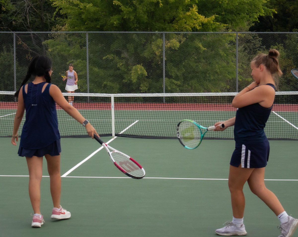 Katie Hyunh and Kaitlyn Morgan celebrate a good point in their match against Holt High School that ended in a sweep of 5-0.