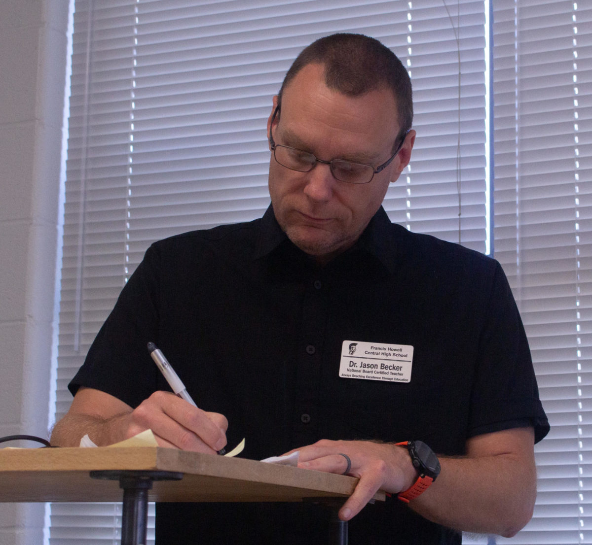 Dr. Becker grading student papers for a class assignment. He enjoys getting his work done at school in order to have more time in his after-school life to take time to relax. 