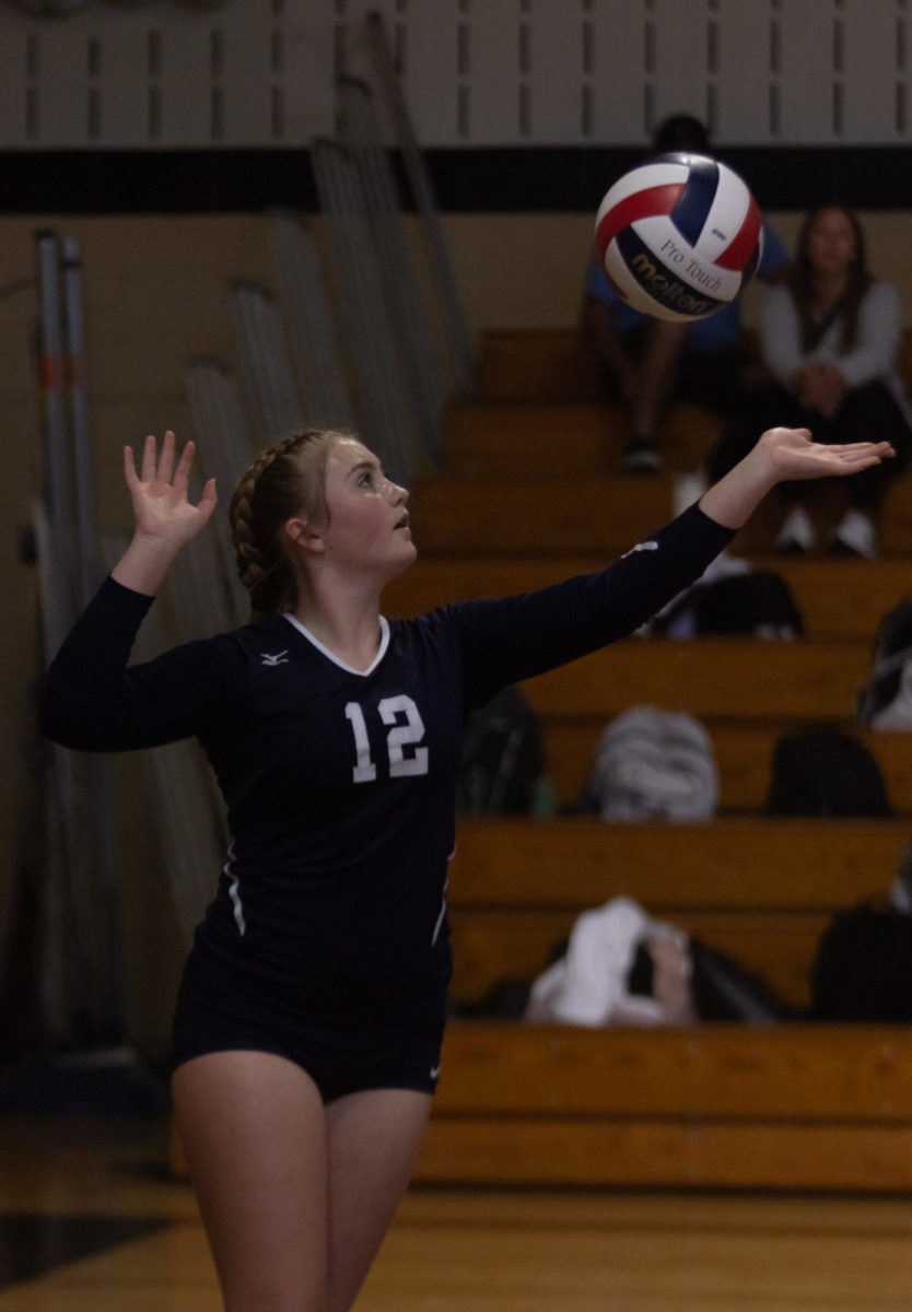 Chloe Horton focuses on the ball, making sure she doesnt miss her serve against Francis Howell North.