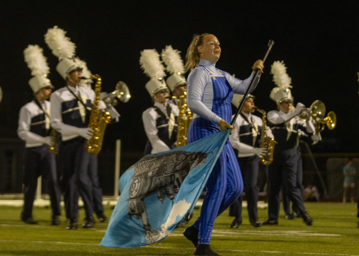 Maggie Skebo performs her Color Guard choreography alongside the Marching Band. She smiled at the crowd, proud to show off her art.