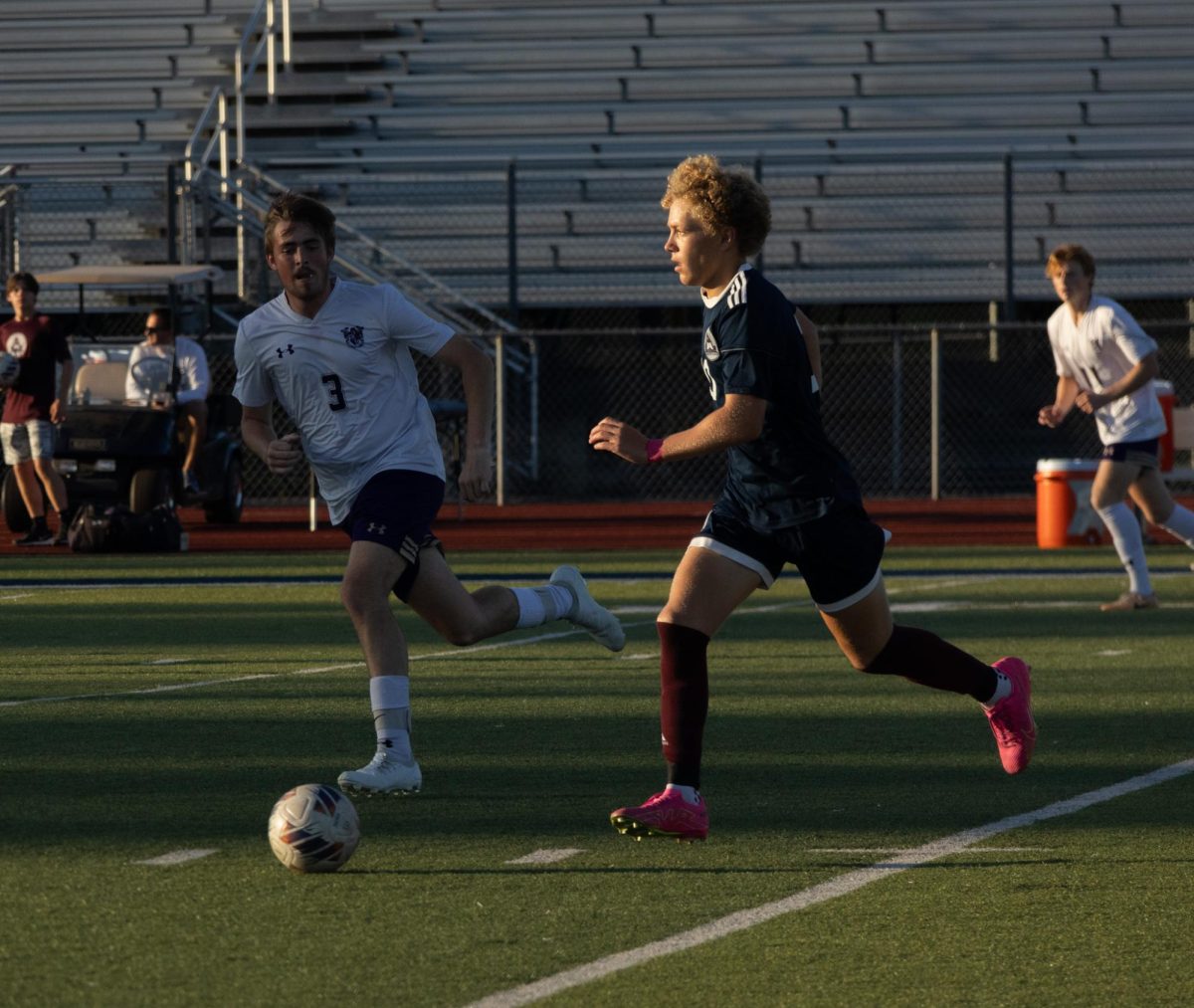 During varsity soccer’s game against Troy High School, Carter Radeke runs down the field with the ball. Radeke then quickly passes the ball to a teammate where they later scored a goal and won the game 2-0.