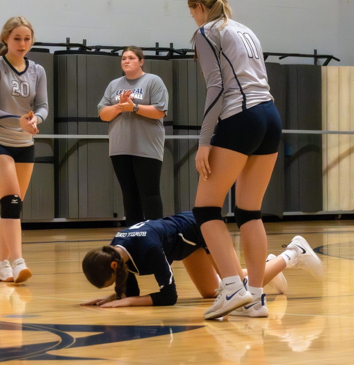 Freshman Natalie Hirth slams the ground in frustration as the Timberland players earn a point. The ball was shy of making it over the net.