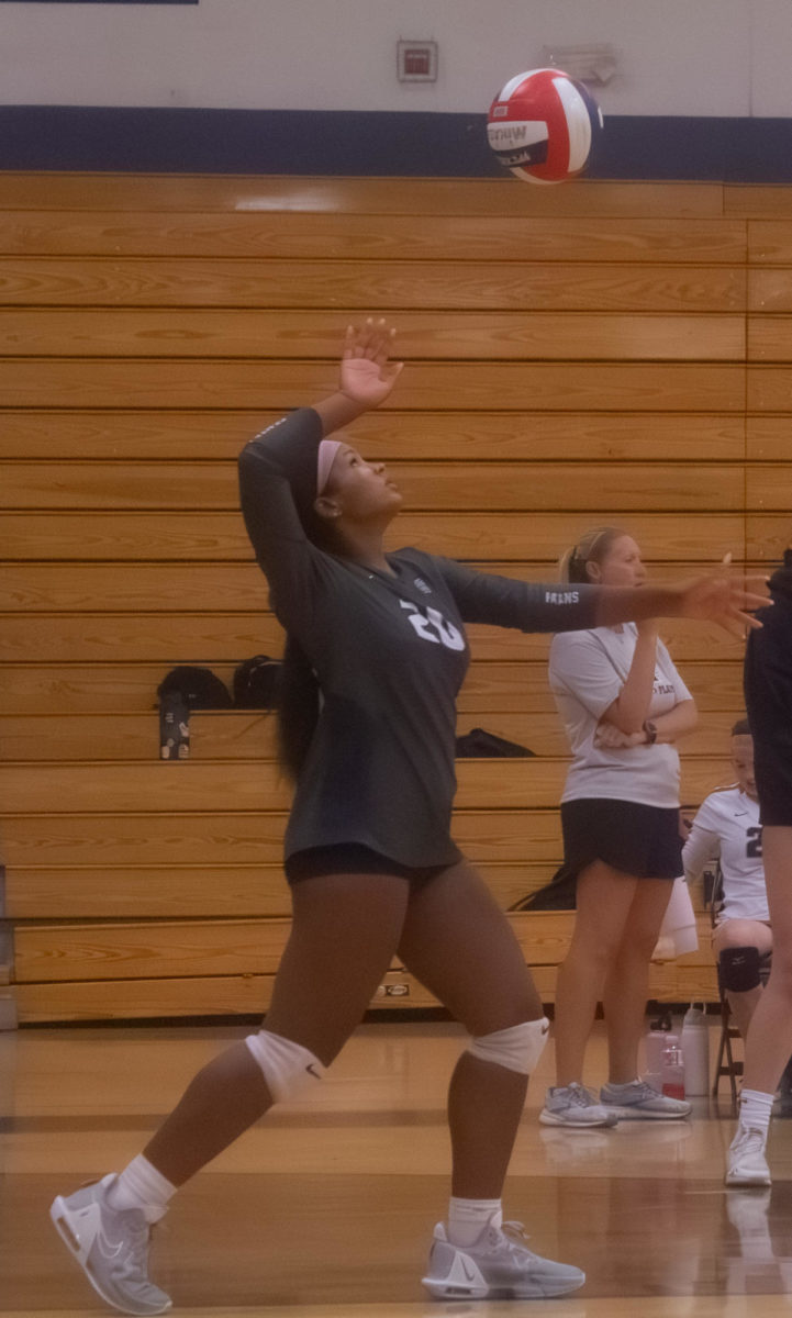 Sophomore+Bella+Cowherd+serves+overhand+in+the+first+set+of+the+game+on+Oct.+3rd.%0A