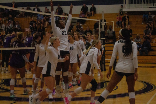 The volleyball team cheers after a dominate victory. They took all three sets against Fort Zumwalt West. 