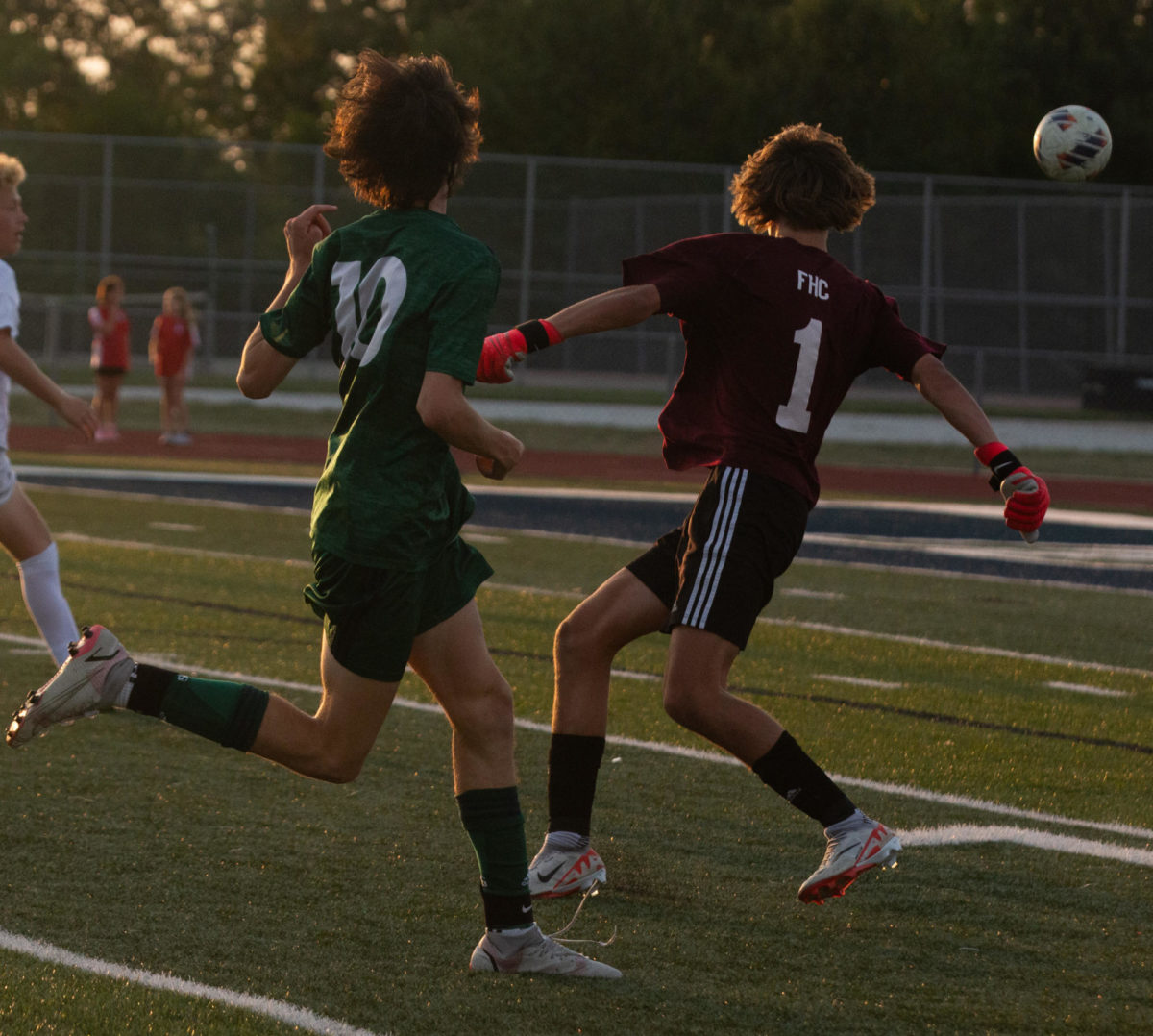 The goalie, Cooper Kambak, leaves the goal to block the opponent from getting the ball.