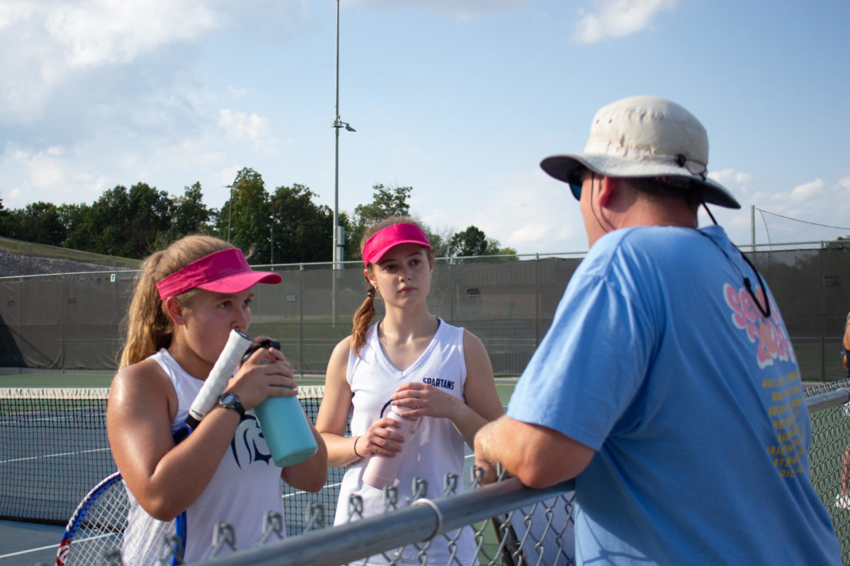 Coach Reed talking to Bethany List and Kate Baranowski after a game point 