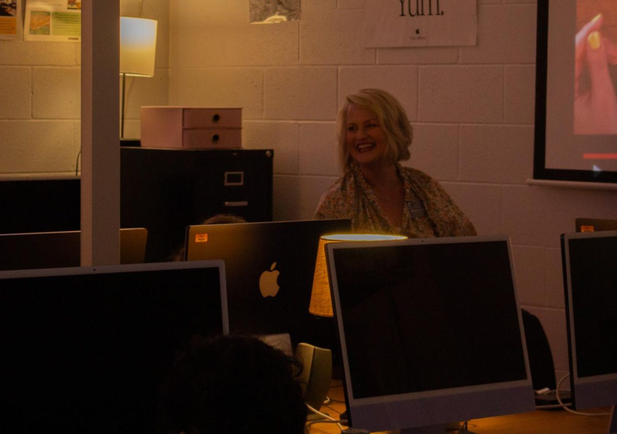 Mrs. McCune smiles across the room talking to a student. She was teaching her Digital Art & Design I class. 