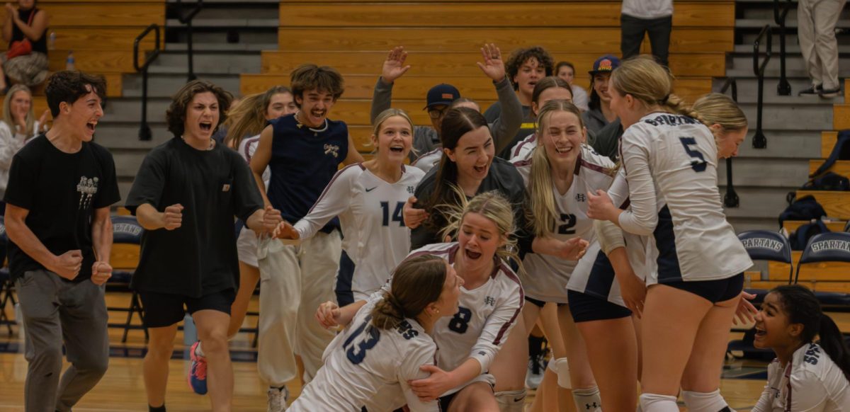The girls varsity volleyball team is elated after the last point of the final match. The girls have just won districts for their 2023 season on Oct 24. 