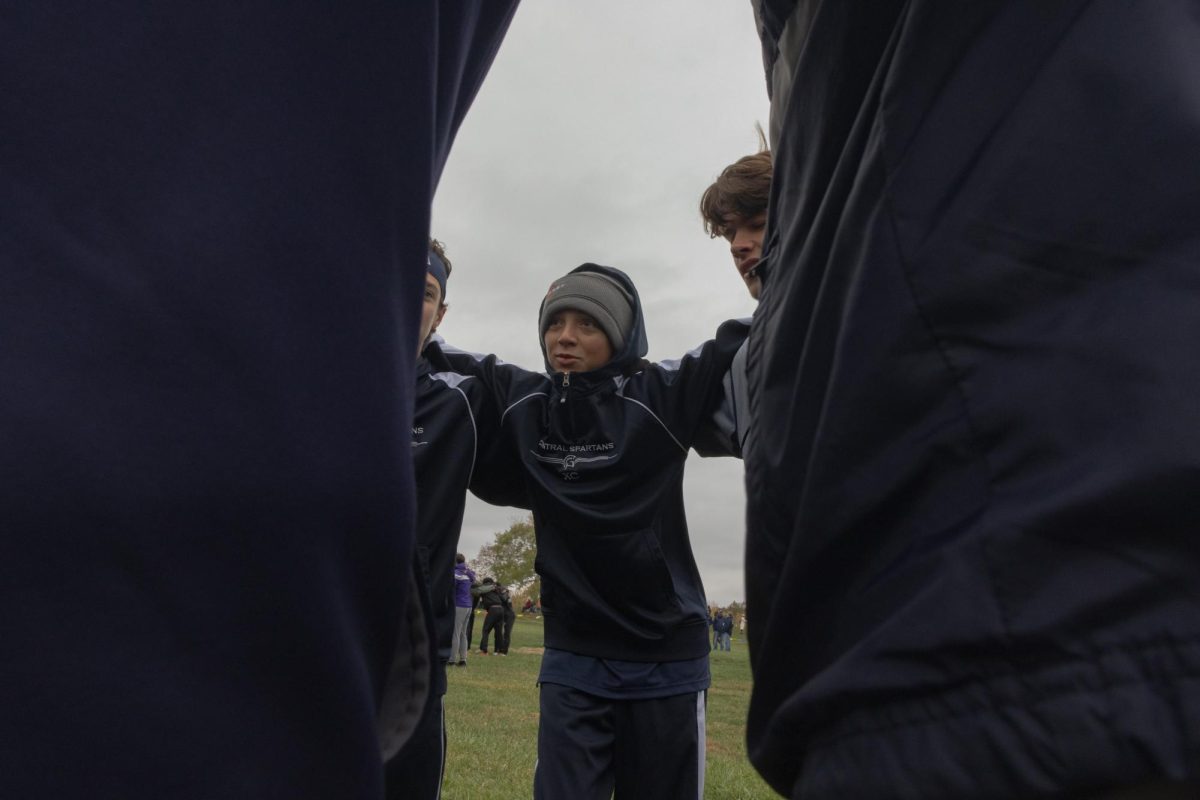 Freshman Charlie Renken speaks in the final huddle to hype them up before they have their final race of the season. 