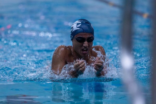 Junior Aadit Mehta comes up for a brief bit of air during the breaststroke race.