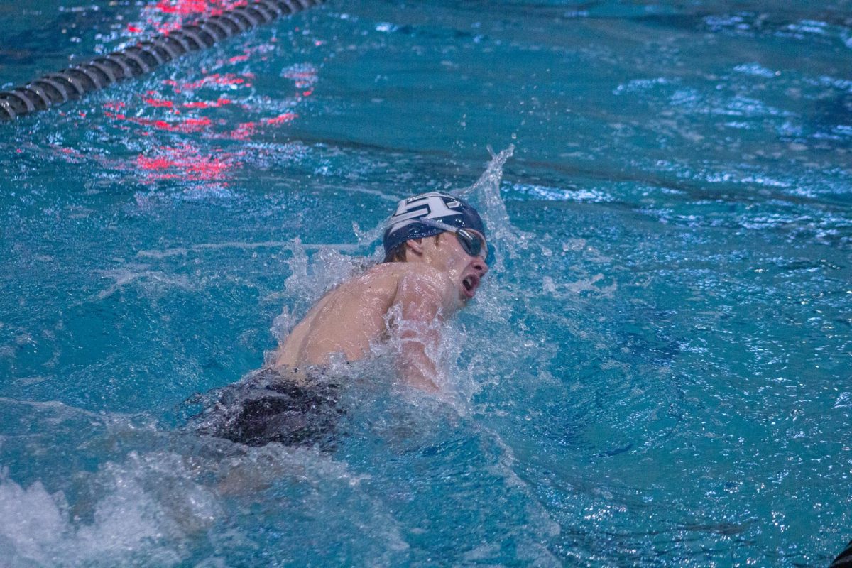 Junior Connor Casey comes up for fresh air during his freestyle race. 
