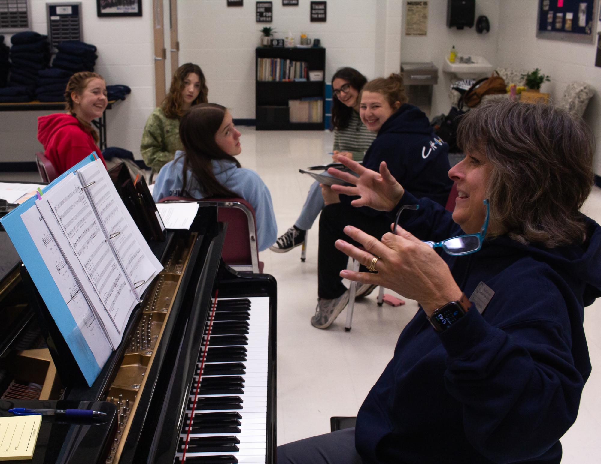 Mrs. Solverud laughs with her alto section during chamber choir. She has built a relationship with all of these students and knows them well. 