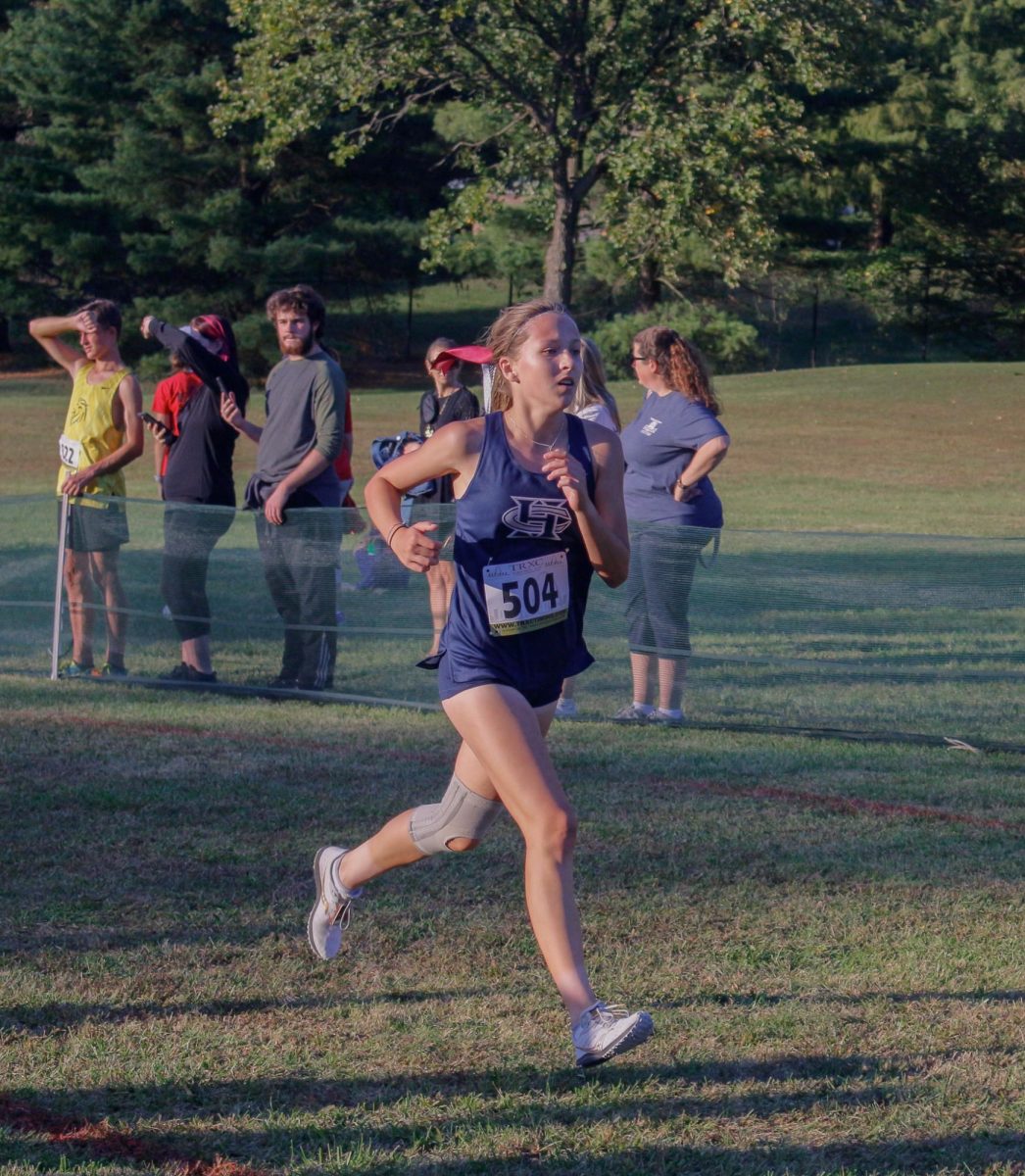 Freshman Rachael Latzel races towards the finish line in the final stretch of the race.
