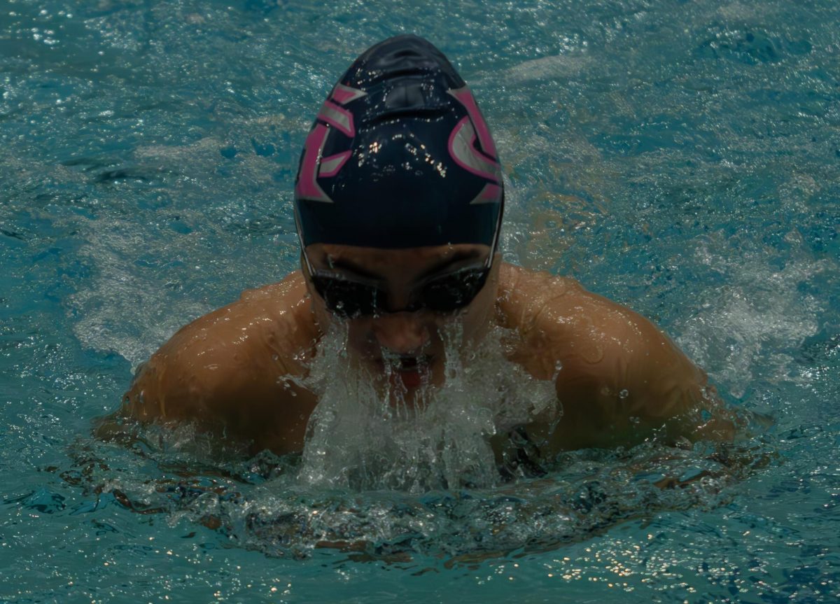 Freshman Vika Anderson slices through the water during the breaststroke relay. This was Anderson’s first meet on the varsity swim team.