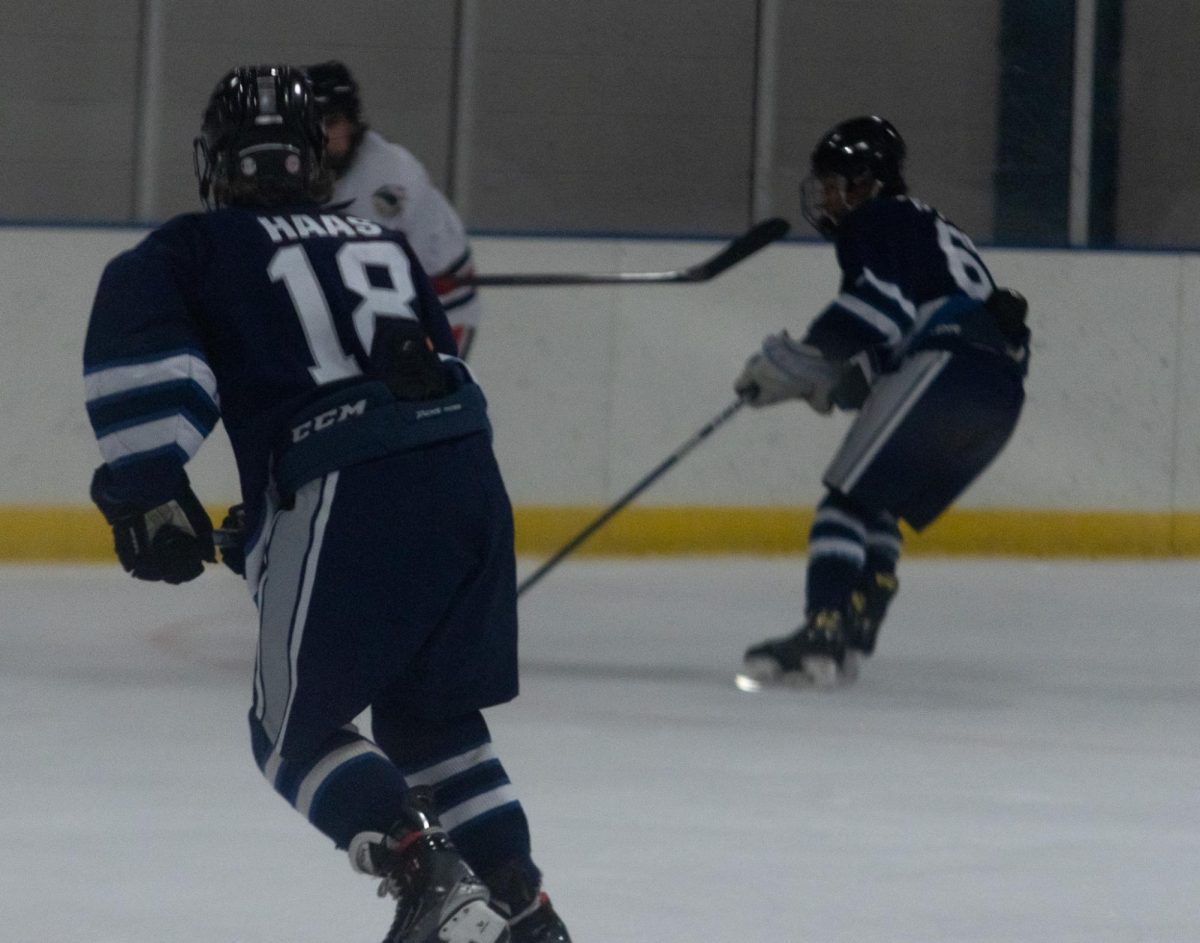 Jacob Haas skates toward his teammate to help keep the puck in Centrals possession.