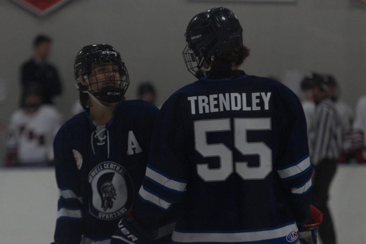Aiden Lee stops to talk to his teammate, Seeger Trendley, before the next face-off.