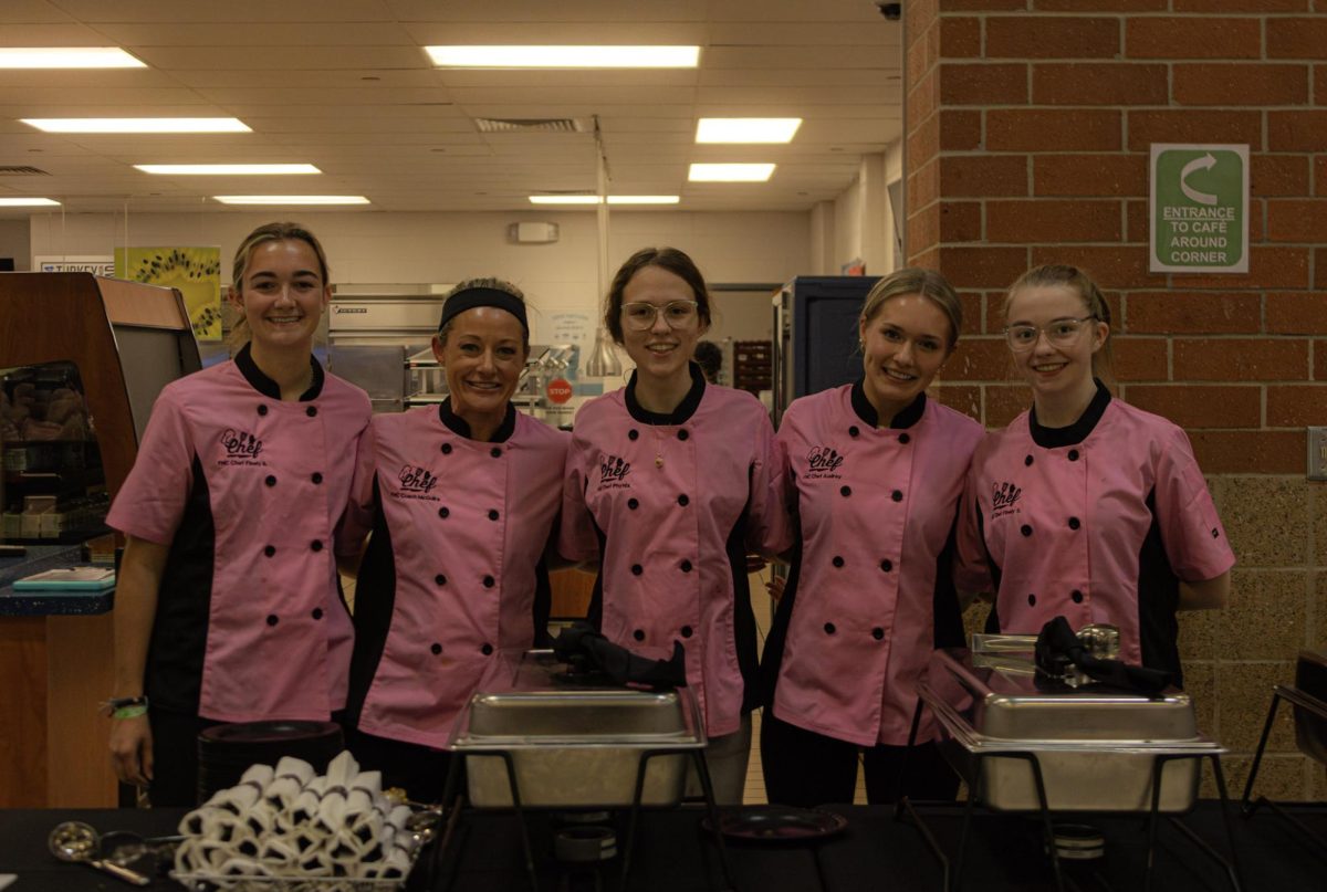 The Spartan chef team joins together in front of their table full of food. They were joined by Francis Howell and North at Francis Howell on Nov. 9 for the competition. 

