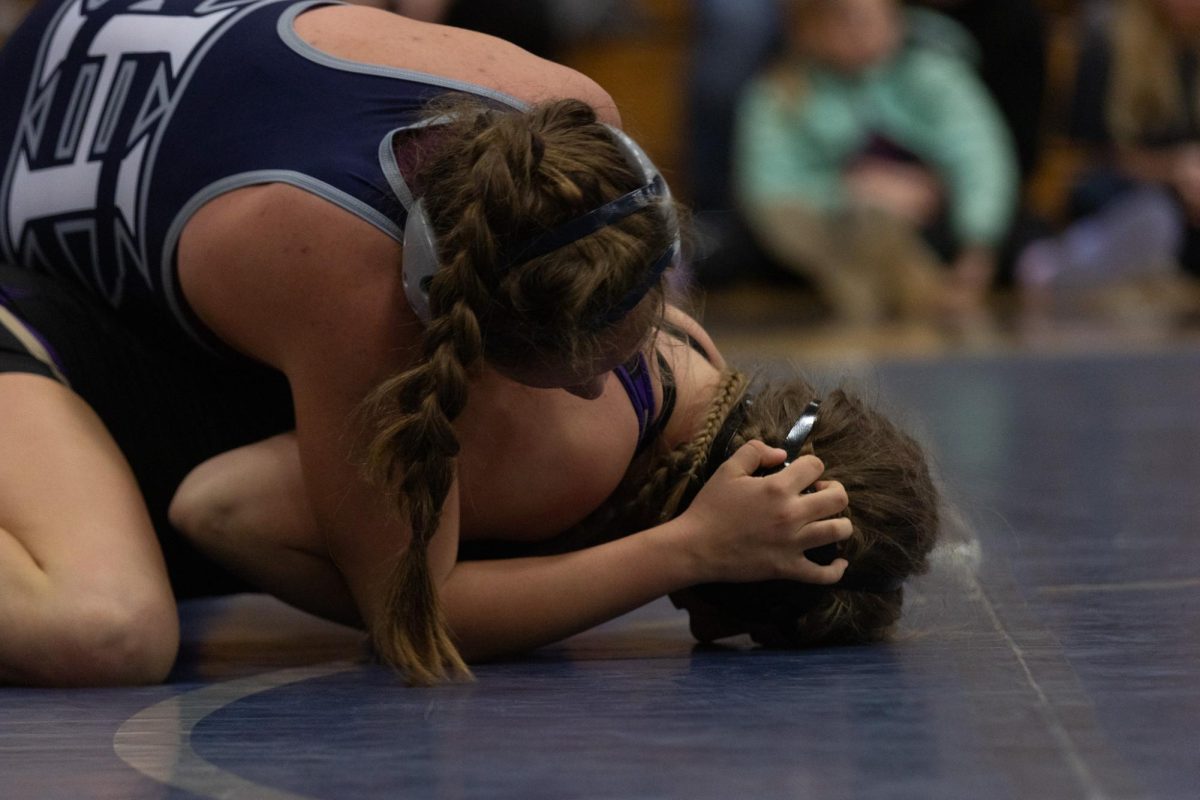 Sophomore Rose Chamberlain looks for a way to pin her opponent. 