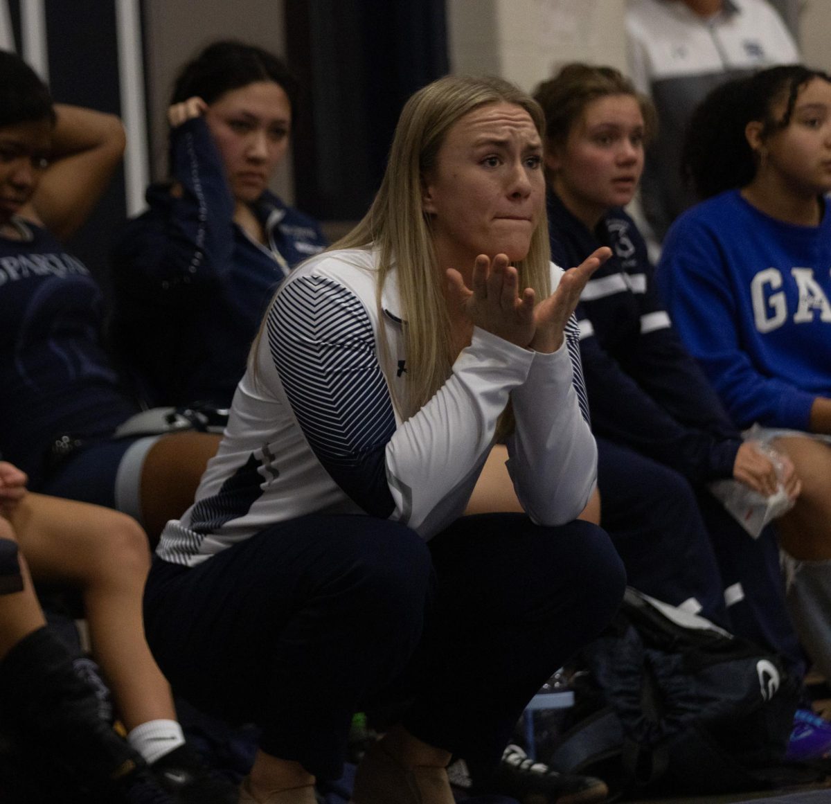 Coach Kennedy Eggering throws her hands out with frustration. Eggering is also a former FHC wrestler. 