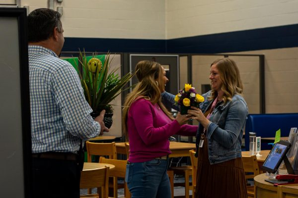 Mrs. LaMartina receives flowers from Ms. Fay along with her Teacher of the Year award. The group was laughing and smiling along with Mrs. LaMartina.