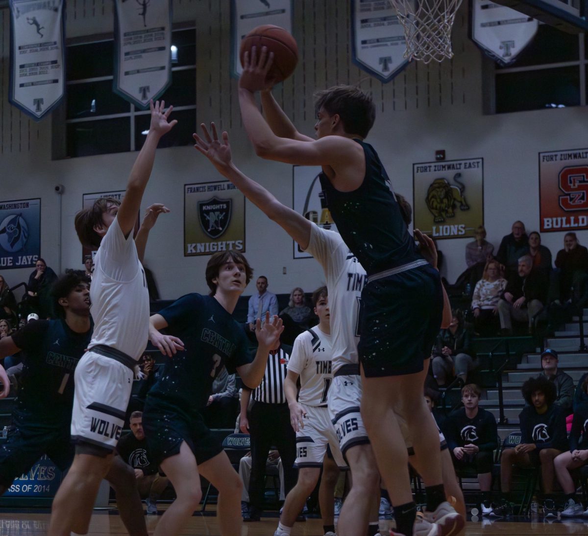Senior Nate Rush throws the ball down to the end of the court to his teammates so that they can score some more points during the Timberland game. 