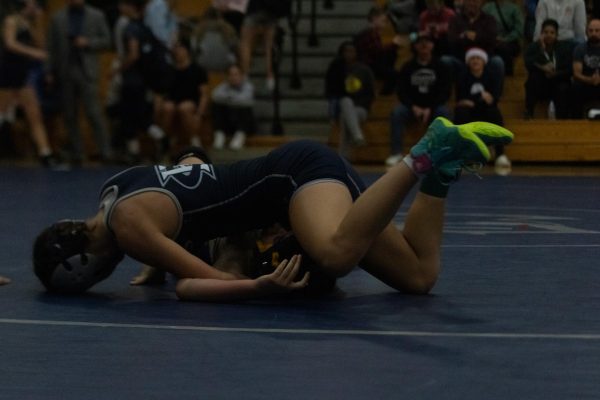 Senior, Camrin Watkins, pins the opponent not long after the match starts. Right off the bat, she dominated the match quickly getting the other girl on the mat.