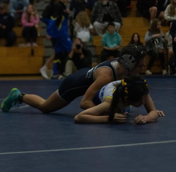 Senior Camrin Watkins pins her opponent at a meet on December 13th against Howell. 