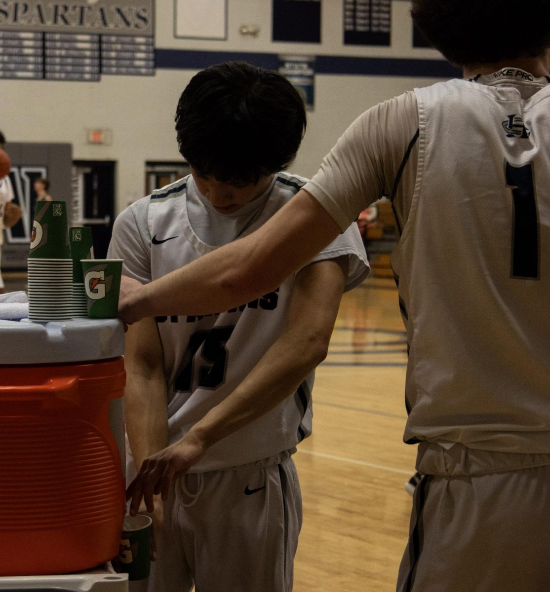 Before the second half started, sophomore Rico Helwig-Diaz gets a drink of water to replenish himself for the next half of the game. The Trojans were leading on the scoreboard at halftime. 