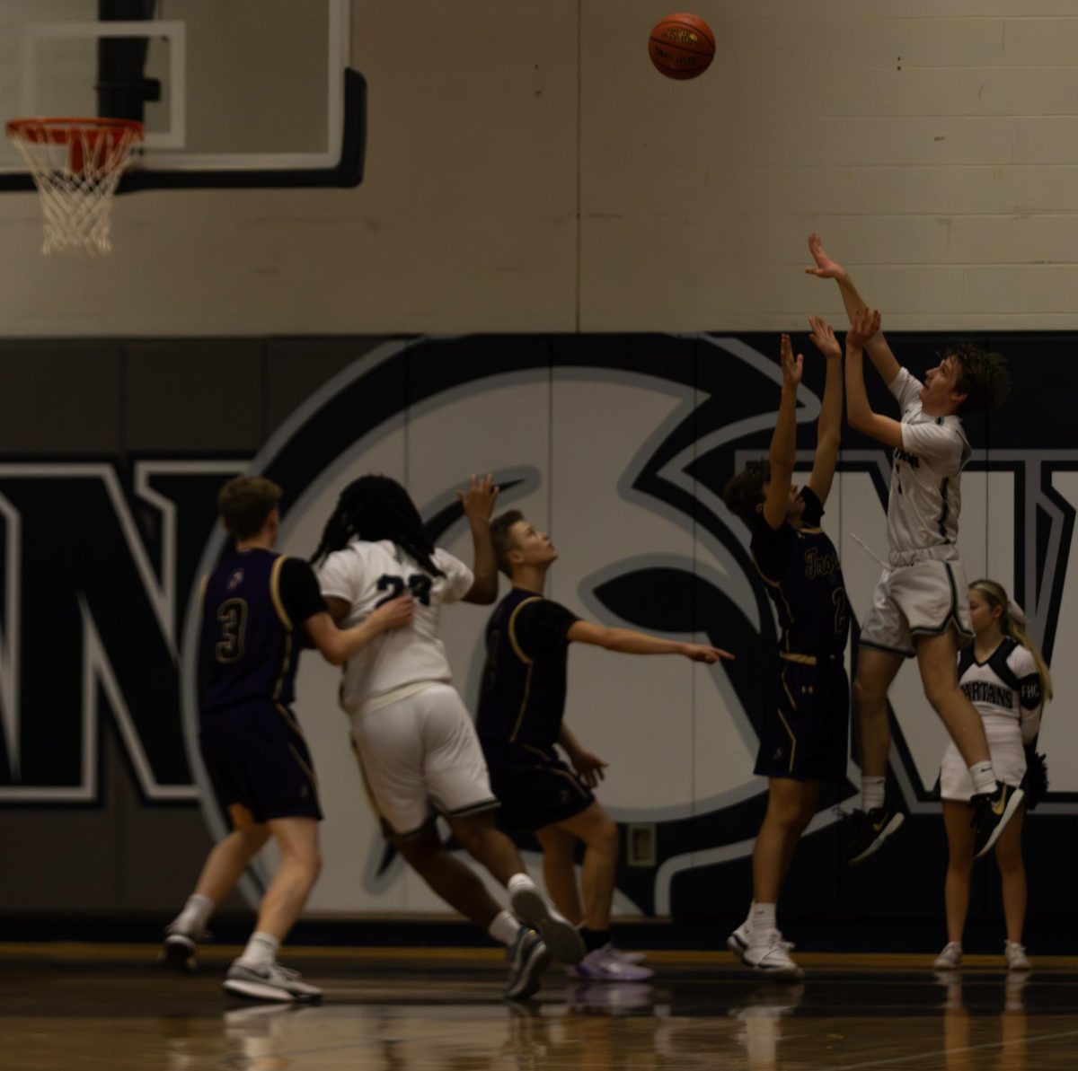 Sophomore Dylan Davis throws up a shot over his defenders arms. 