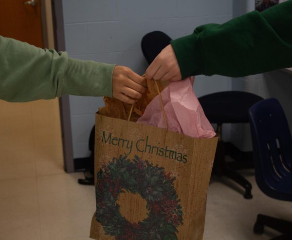 Students exchanging gifts for the holidays through special events like Secret Santa. Many people use gift-giving as a way to love others.