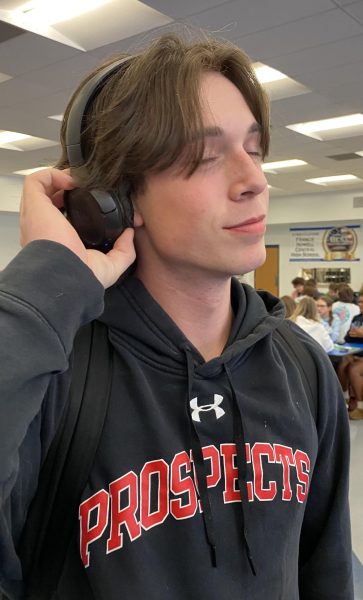 Junior Noah Gunnar positions his headphones on his ears. Music acts as a calming stress reliever.