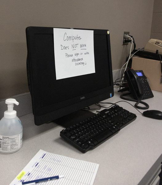 A computer with a note on it reading, Computer...does NOT work...Please sign in with attendance secretary, after the lack of Wi-fi made technology and teaching with technology impossible. 